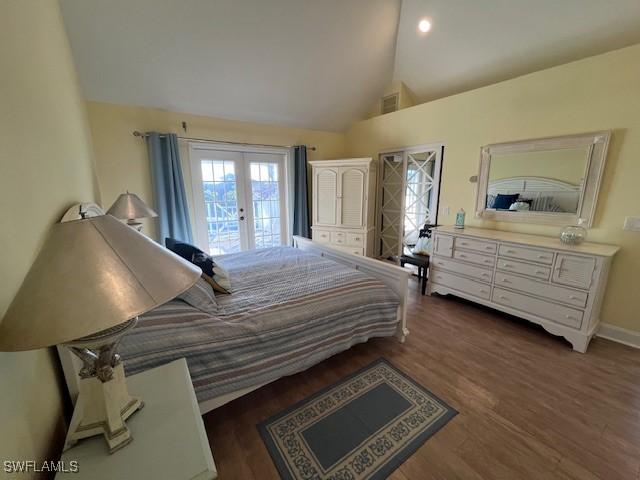 bedroom with high vaulted ceiling, dark wood-type flooring, access to outside, and french doors