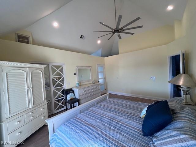 bedroom with ceiling fan, dark hardwood / wood-style flooring, and high vaulted ceiling