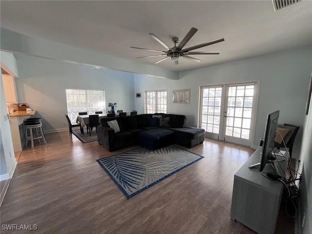 living room featuring dark hardwood / wood-style flooring, ceiling fan, plenty of natural light, and french doors