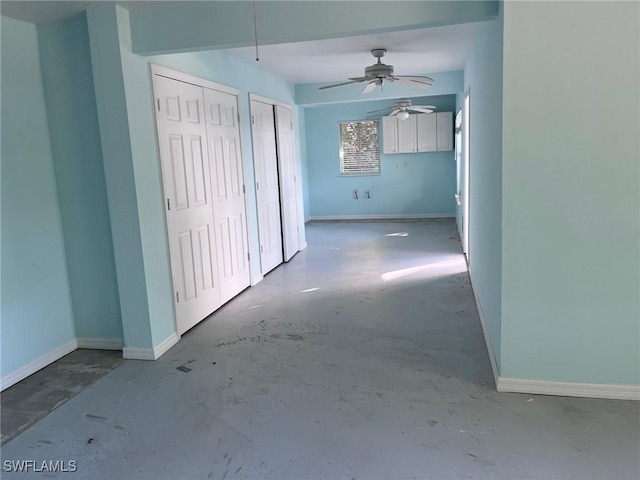 interior space with ceiling fan and concrete flooring