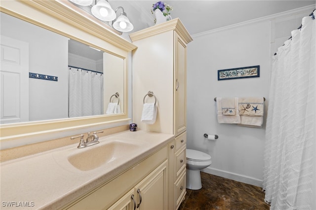 bathroom featuring vanity, toilet, and crown molding