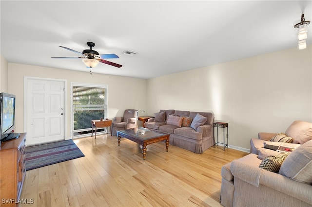 living room featuring light hardwood / wood-style floors and ceiling fan