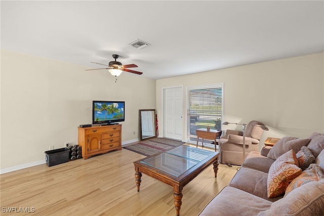 living room with ceiling fan and light wood-type flooring