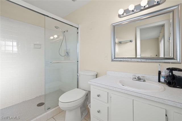 bathroom featuring tile patterned flooring, vanity, an enclosed shower, and toilet