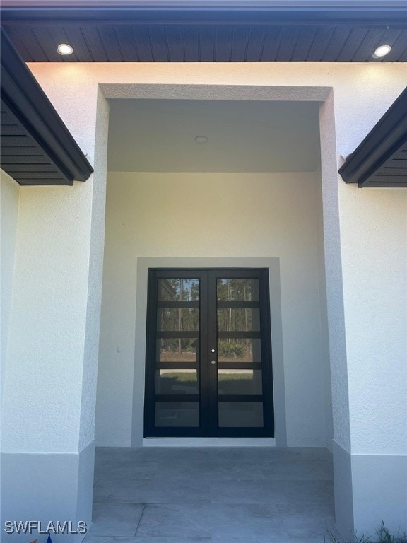 view of exterior entry featuring french doors