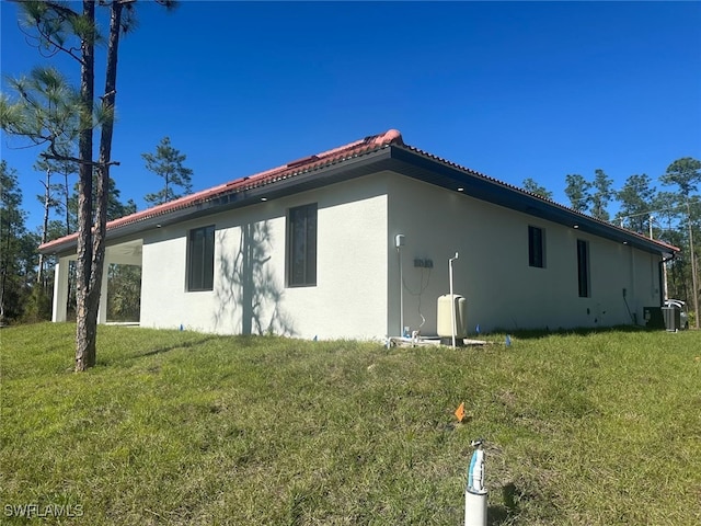 view of side of property with a yard