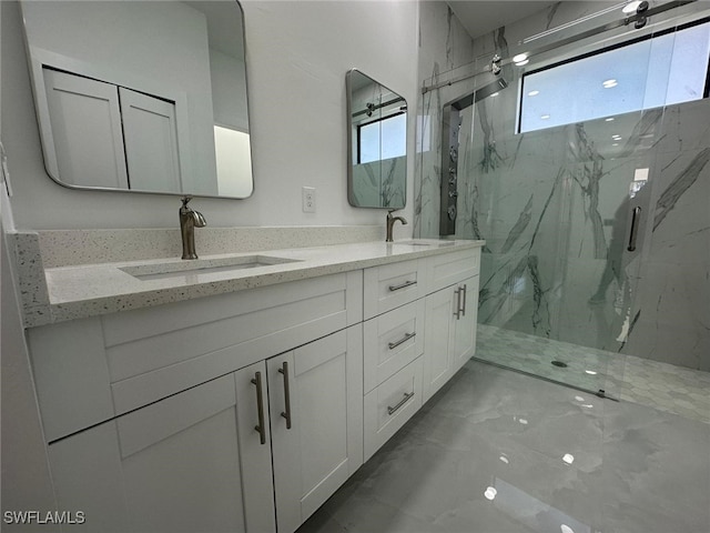 bathroom featuring vanity and a shower with door