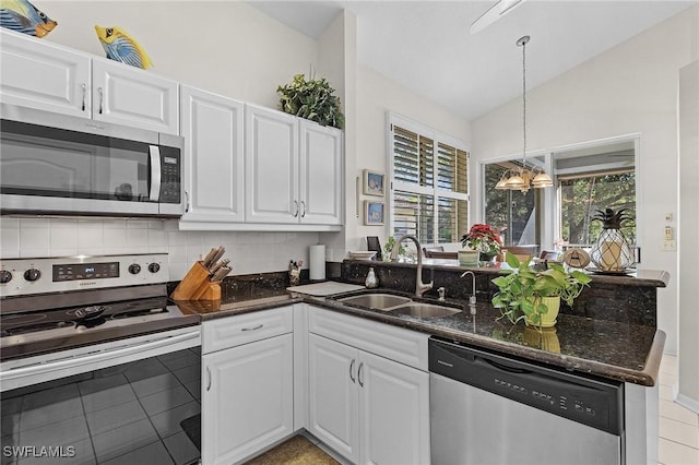 kitchen featuring sink, white cabinets, stainless steel appliances, and lofted ceiling