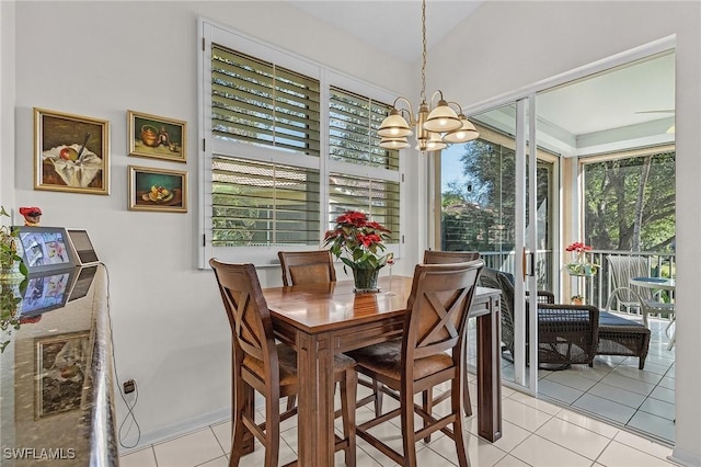 dining space featuring light tile patterned flooring, lofted ceiling, and a notable chandelier