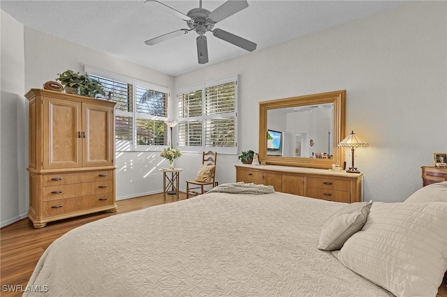 bedroom with ceiling fan and hardwood / wood-style floors