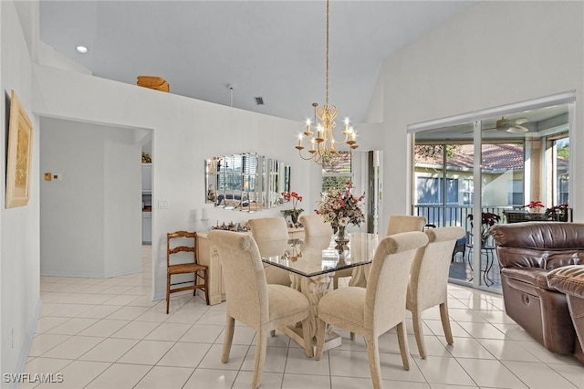 tiled dining room featuring high vaulted ceiling and an inviting chandelier