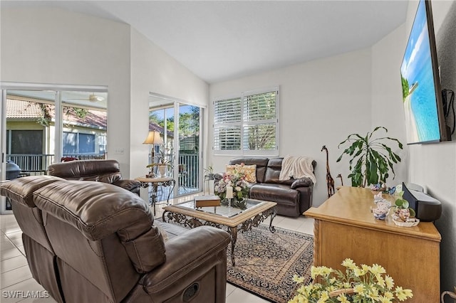 living room featuring lofted ceiling and light tile patterned floors