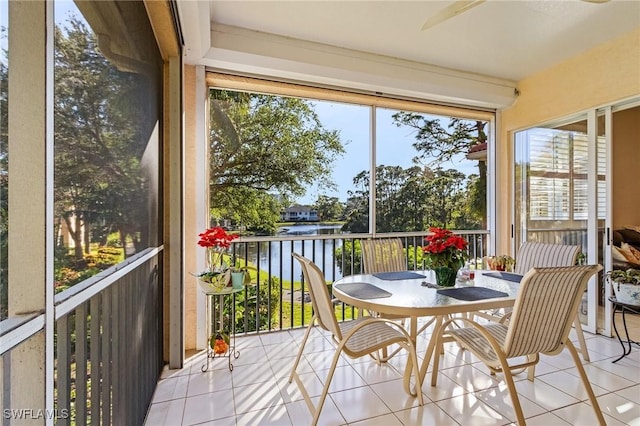 sunroom with a water view and a healthy amount of sunlight