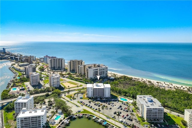 birds eye view of property featuring a beach view and a water view