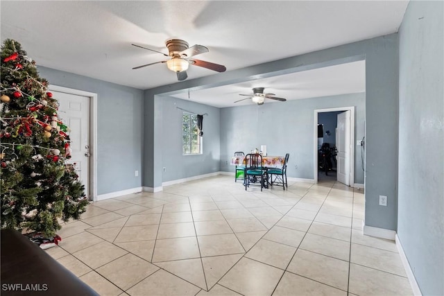 unfurnished dining area featuring ceiling fan and light tile patterned floors