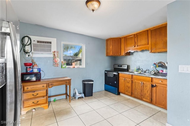 kitchen featuring light tile patterned floors, a wall unit AC, and electric stove