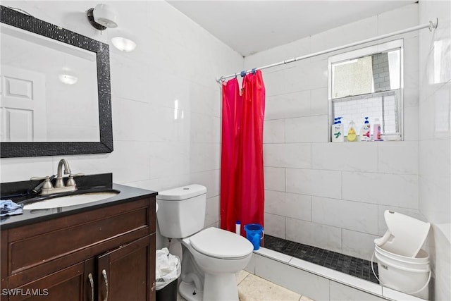 bathroom with walk in shower, vanity, tile walls, tile patterned flooring, and toilet