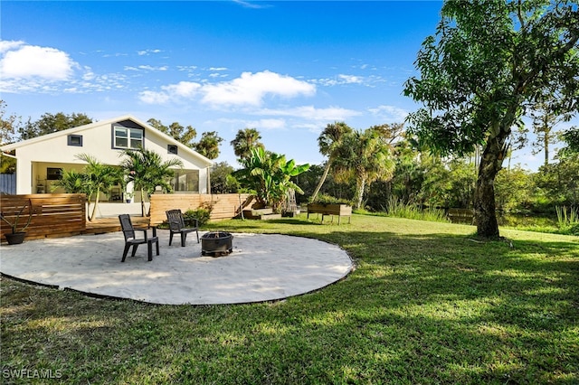 view of yard with an outdoor fire pit, a patio area, and fence