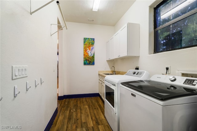 laundry room featuring cabinets, dark hardwood / wood-style flooring, independent washer and dryer, and sink