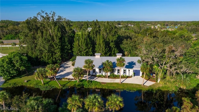 bird's eye view with a forest view and a water view