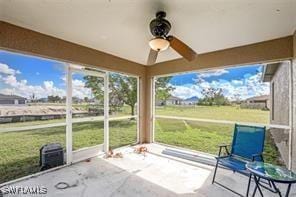 unfurnished sunroom featuring ceiling fan