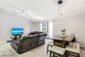 tiled living room with ceiling fan