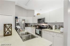 kitchen with white cabinetry, sink, and appliances with stainless steel finishes