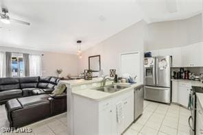 kitchen with white cabinetry, sink, stainless steel refrigerator with ice dispenser, pendant lighting, and light tile patterned floors