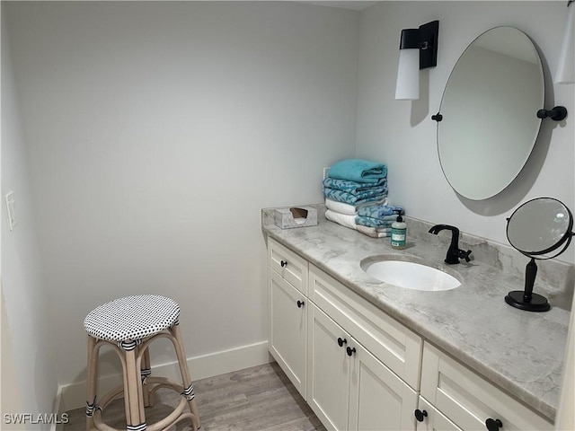 bathroom featuring hardwood / wood-style floors and vanity