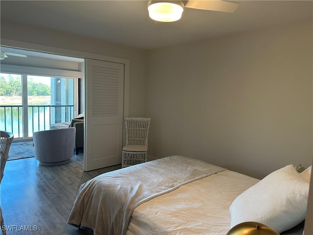 bedroom with access to outside, dark hardwood / wood-style floors, and ceiling fan