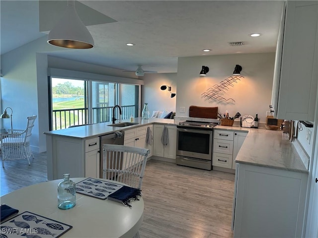 kitchen featuring kitchen peninsula, stainless steel appliances, sink, light hardwood / wood-style flooring, and white cabinets