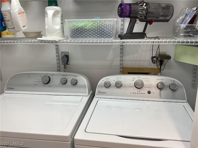 clothes washing area featuring washer and clothes dryer