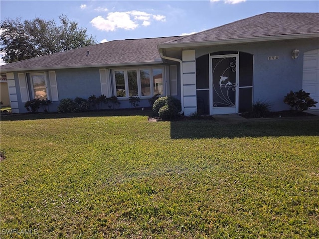 view of front of home with a garage and a front yard