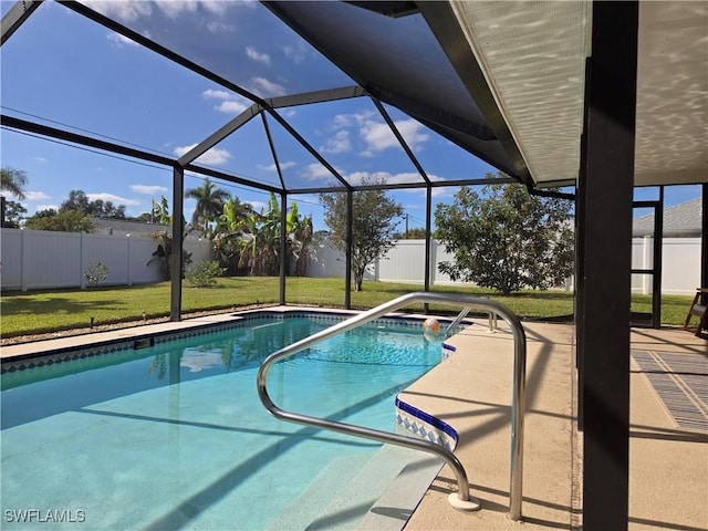 view of swimming pool with a lanai, a lawn, and a patio