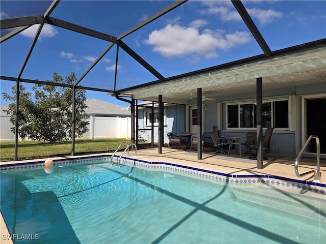 view of swimming pool with ceiling fan, glass enclosure, and a patio area