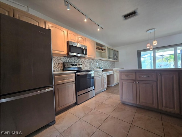 kitchen with pendant lighting, backsplash, stainless steel appliances, and light tile patterned flooring