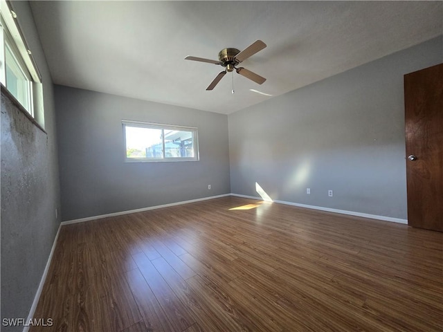 spare room featuring ceiling fan and dark hardwood / wood-style flooring