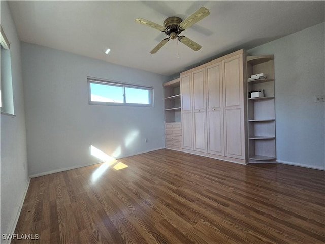 unfurnished bedroom featuring ceiling fan, dark hardwood / wood-style flooring, and a closet