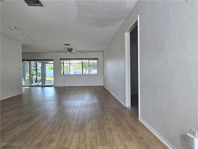 unfurnished room with ceiling fan and hardwood / wood-style floors