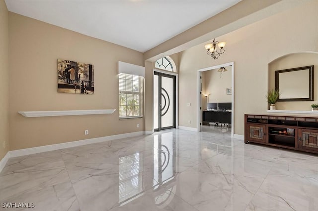 entryway with a chandelier