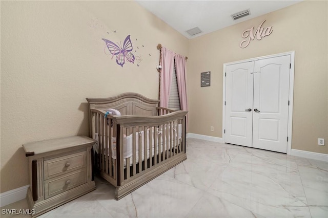 bedroom with a nursery area and a closet