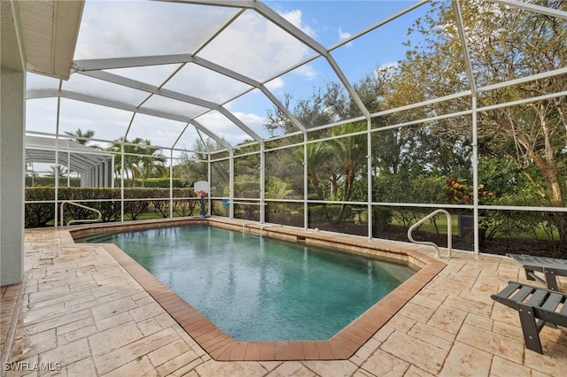 view of pool featuring a patio and glass enclosure