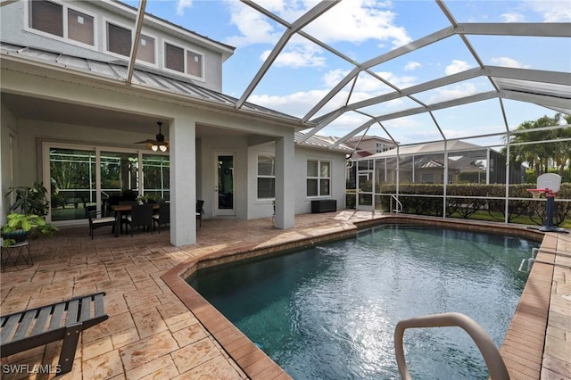 view of pool with a patio area and glass enclosure