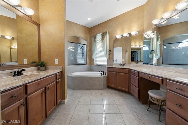 bathroom with vanity, tile patterned floors, and tiled bath