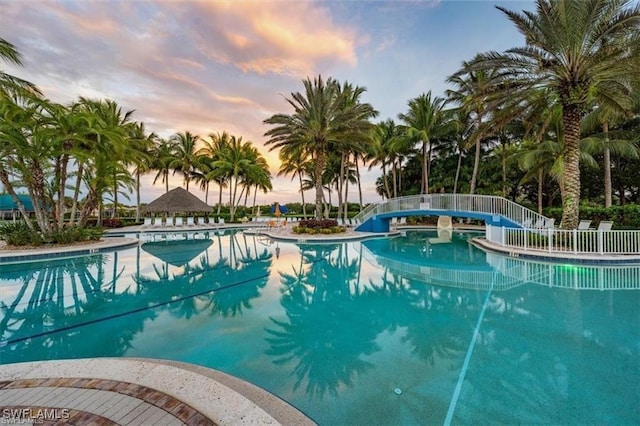 pool at dusk with a water slide