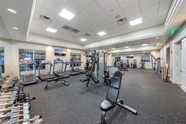 gym with a tray ceiling and a drop ceiling