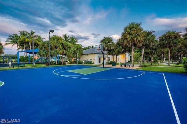 view of basketball court featuring a playground