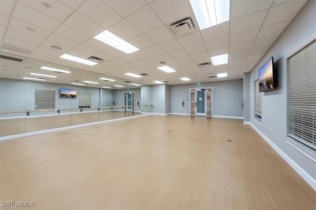 interior space featuring light hardwood / wood-style flooring and a drop ceiling