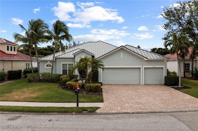 view of front of house with a garage and a front yard