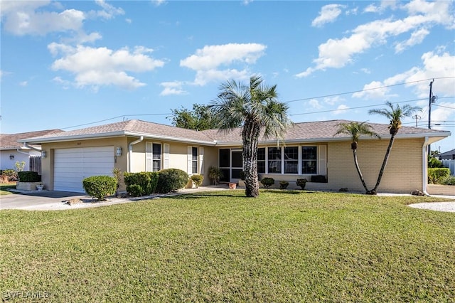 single story home with a garage and a front lawn